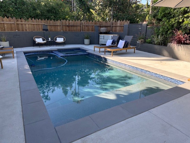 Modern Resort Pool with Fire Pit in Baker